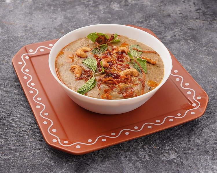 Traditional Hyderabadi haleem food prepared with wheat, lentils, and slow-cooked meat
